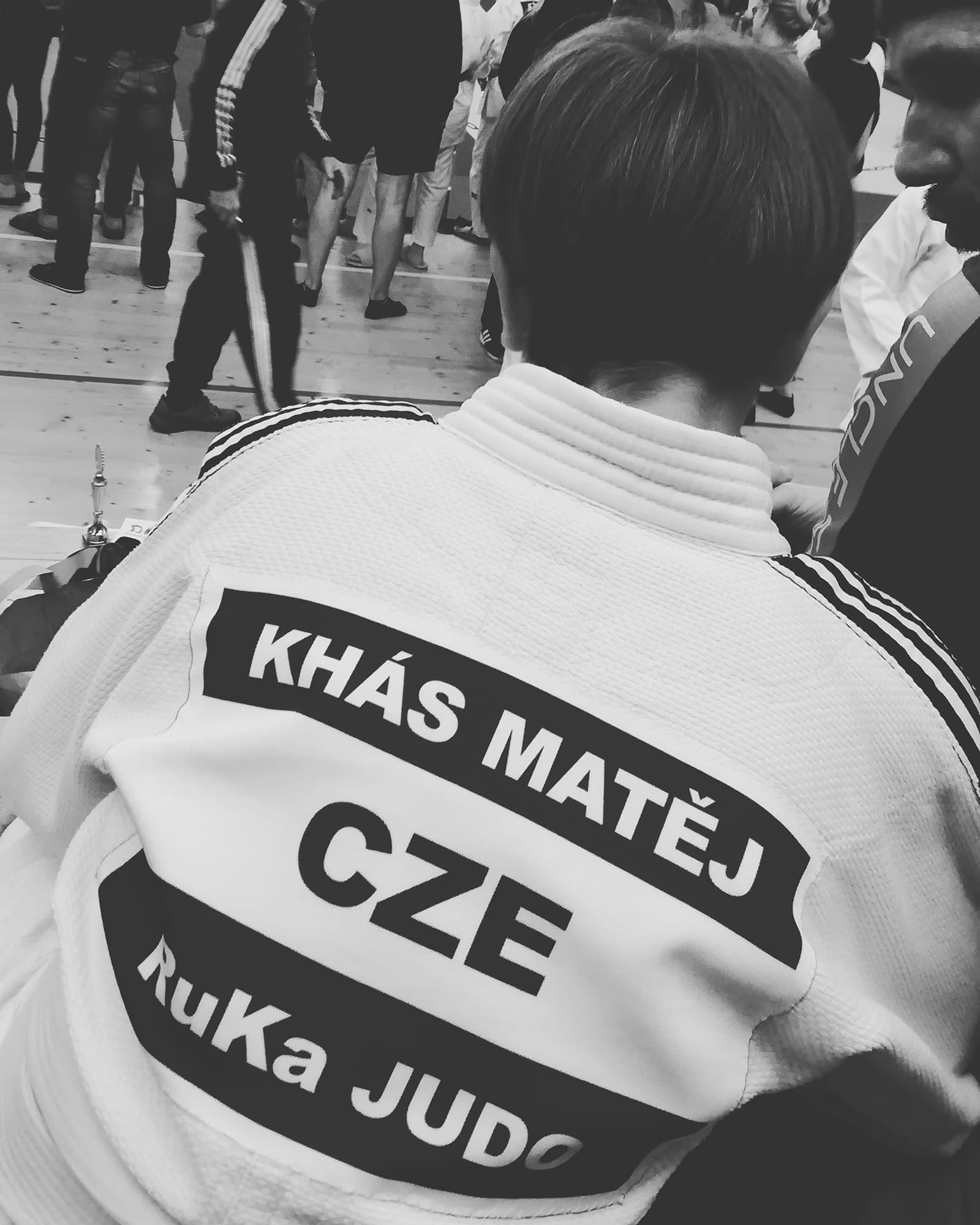 Black-and-white close-up of a judogi back with RuKa JUDO patch